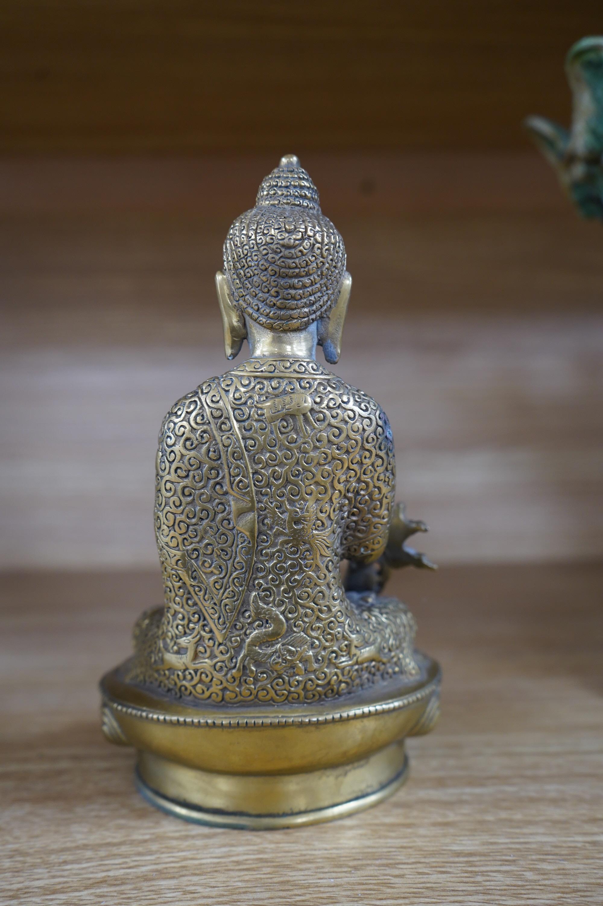 A Tibetan bronze model of a seated Buddha, 19cm. Condition - fair to good